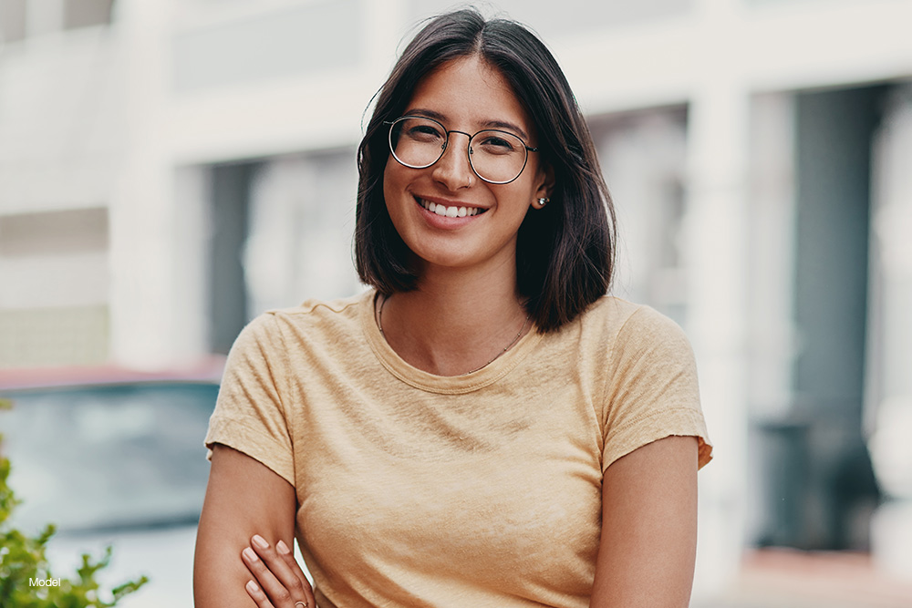 A woman in a yellow shirt smiling
